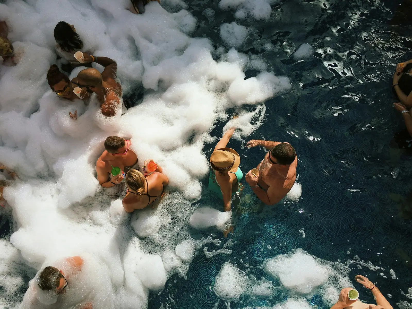 People sitting in icy water seen from above
